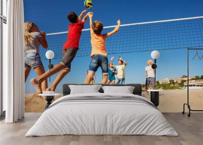 Beach volleyball players jumping to spike the ball Wall mural