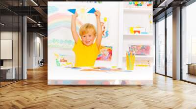 Blond cute boy learning shapes holding triangles Wall mural