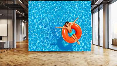 Boy swim on inflatable ring view from above Wall mural