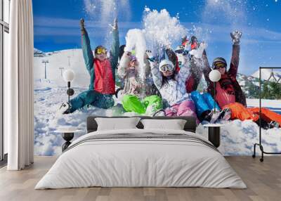 funny happy friends with snowboards throwing snow Wall mural