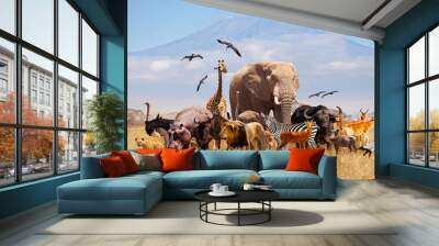 Group of many African animals giraffe, lion, elephant, monkey and others stand together in with Kilimanjaro mountain on background Wall mural