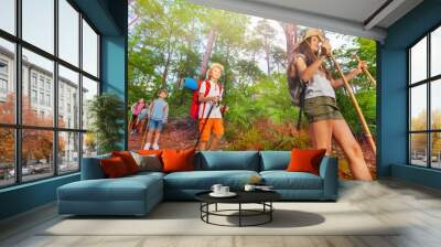 Group of scout kids walk in the forest Wall mural