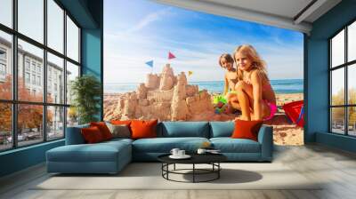 Happy boy and girl playing beach games in summer Wall mural