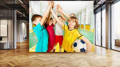 Happy football winners giving high five together Wall mural