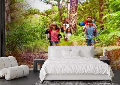 Kids running in the forest on school trip activity Wall mural