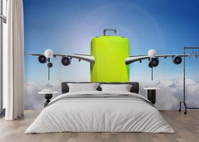 Suitcase with wings fly in clouds - travel concept Wall mural