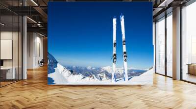 Two skies in snow on mountain ski resort Wall mural