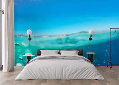 Underwater split images of pool water surface and sky Wall mural