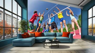 View from below of teens playing volleyball Wall mural