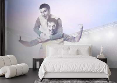 double exposure photo of stadium and soccer or football players celebrating goal with jersey on head Wall mural