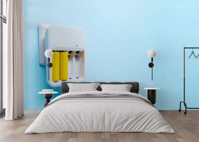 Photo of charger with two yellow batteries Wall mural