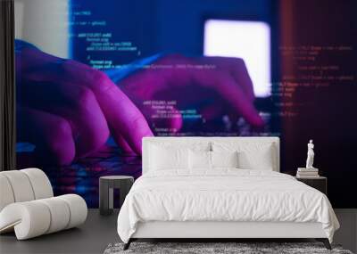 programmer or hacker coding on laptop in dark room, cyber security concept Wall mural