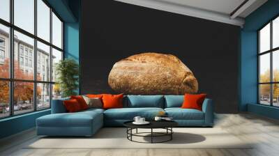 Rustic artisan crusty bread on black background Wall mural