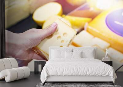 Buyer chooses cheese in store Wall mural