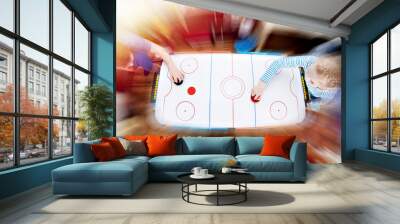 Children playing on table air hockey Wall mural