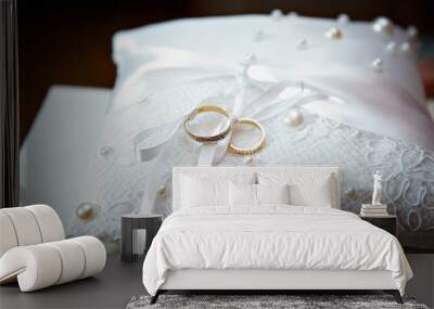 Gold wedding ring on pillow with pearl Wall mural