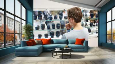 Selecting camera lens in store Wall mural