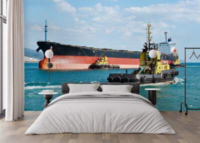 Tanker barge pushed powerful tugboats in sea Wall mural