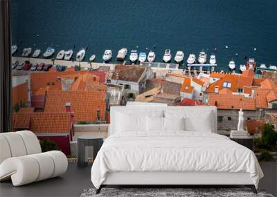 Top view of the red roofs and the pier with boats in the city of Sibenik. Blue, white and red colors of Croatia. Wall mural