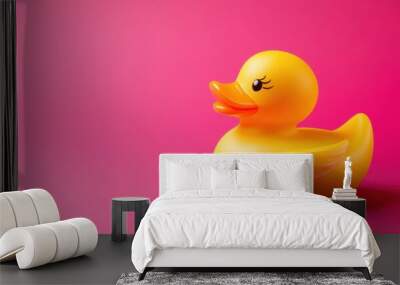 Vibrant yellow rubber duck on pink background Wall mural