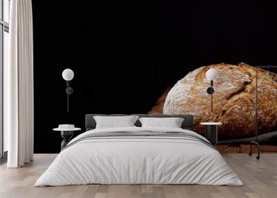 Wheat artisan sourdough bread on a wooden table black background. Panoramic view, free space for text Wall mural