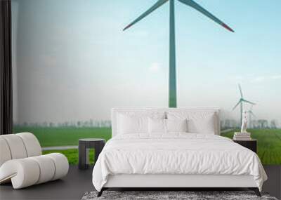 wind generators on a green field under a blue sky on a bright sunny day Wall mural