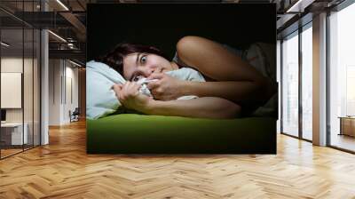 Young woman in bed with eyes opened suffering insomnia. Sleeping concept and nightmare issues Wall mural