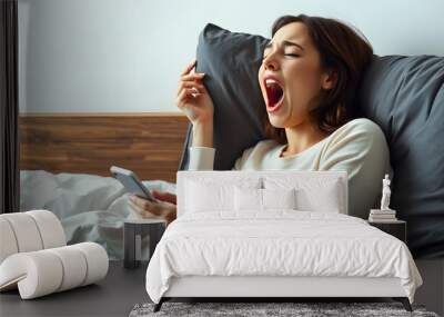 Young yawning tired female using mobile phone in bed, closing open mouth wih hand isolated with white highlights, png Wall mural