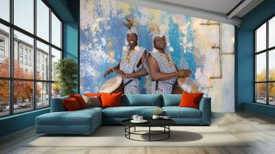 a group of people in traditional african costumes playing jembe drums Wall mural