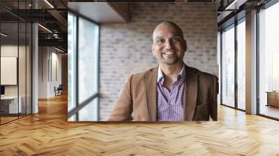 portrait of happy handsome indian business man, smiling, confident and friendly indoors. Wall mural