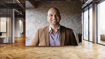 portrait of happy handsome indian business man, smiling, confident and friendly indoors. Wall mural