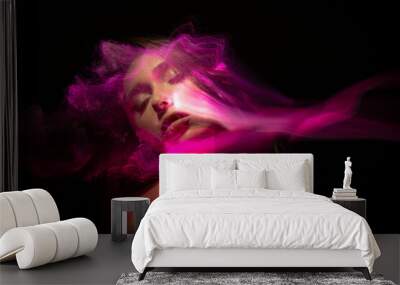 Abstract photography in the style of light painting. girl on a black background Wall mural