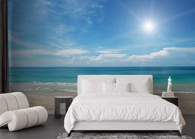 Sandy beach and sun in blue sky Wall mural