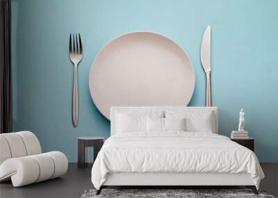 Clean empty white plate with knife and fork Wall mural