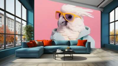 White bird parrot cockatoo wearing glasses and blue hoodie clothes on a pink pastel background. Generated AI. Wall mural