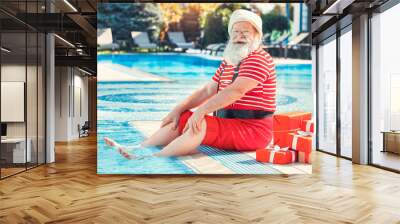 Santa Claus near the pool holiday vacation concept Wall mural