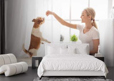 Young person with dog at home leisure Wall mural