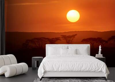 Beautiful sunset in Serengeti National Park plains with acacia trees on the horizon. Wall mural