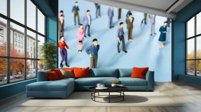 a group of miniature people on a colored surface	 Wall mural