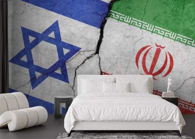 Israel and Iran flags, concrete wall texture with cracks, grunge background, military conflict concept Wall mural