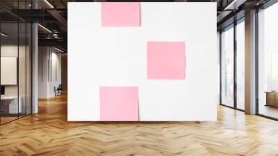 Pink stickers on a white wall, copy space. Layout reminder Wall mural