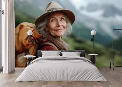 Retirement trip. Active elderly woman traveler traveling in the mountains in nature Wall mural