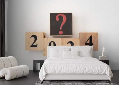 Number 2024 and question mark written on wooden blocks isolated on white background Wall mural