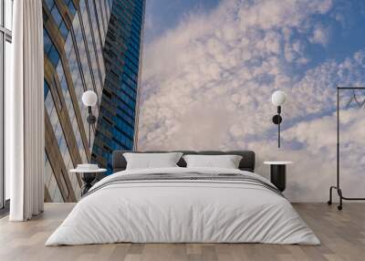 Angled view of modern skyscrapers in business district against blue sky. Looking Up high-rise office buildings. Wall mural