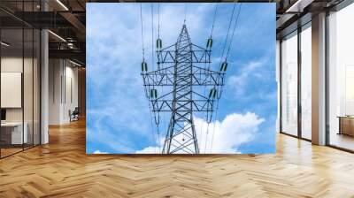 Electricity power pole with transmission lines against blue sky and clouds. Wall mural