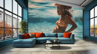 Underwater pregnant woman wearing swimsuit in deep pool Wall mural