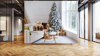 Interior of bright modern living room with comfortable sofa decorated with Christmas tree and gifts Wall mural