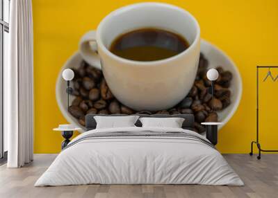 a photo with selective focus with a cup of coffee on a yellow background Wall mural