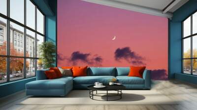 A serene pink and purple gradient sky with a crescent moon Wall mural