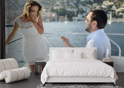  Handsome man doing a marriage proposal on bright sunny day on vacation Wall mural